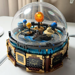 LEGO model of a solar system inside a transparent dome on a white surface.