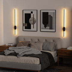Modern bedroom with a bed, nightstands, wall sconces, and abstract art.