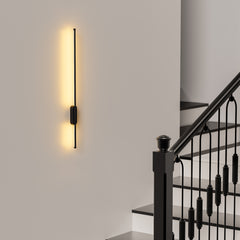 Modern wall-mounted light fixture on a staircase wall
