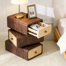 Wooden nightstand with drawers next to a bed in a bedroom setting