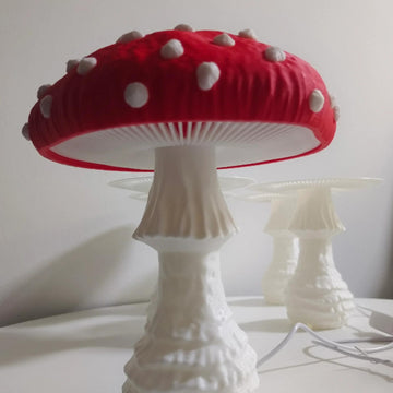 Red mushroom bedside lamp switched off in a bright children’s room